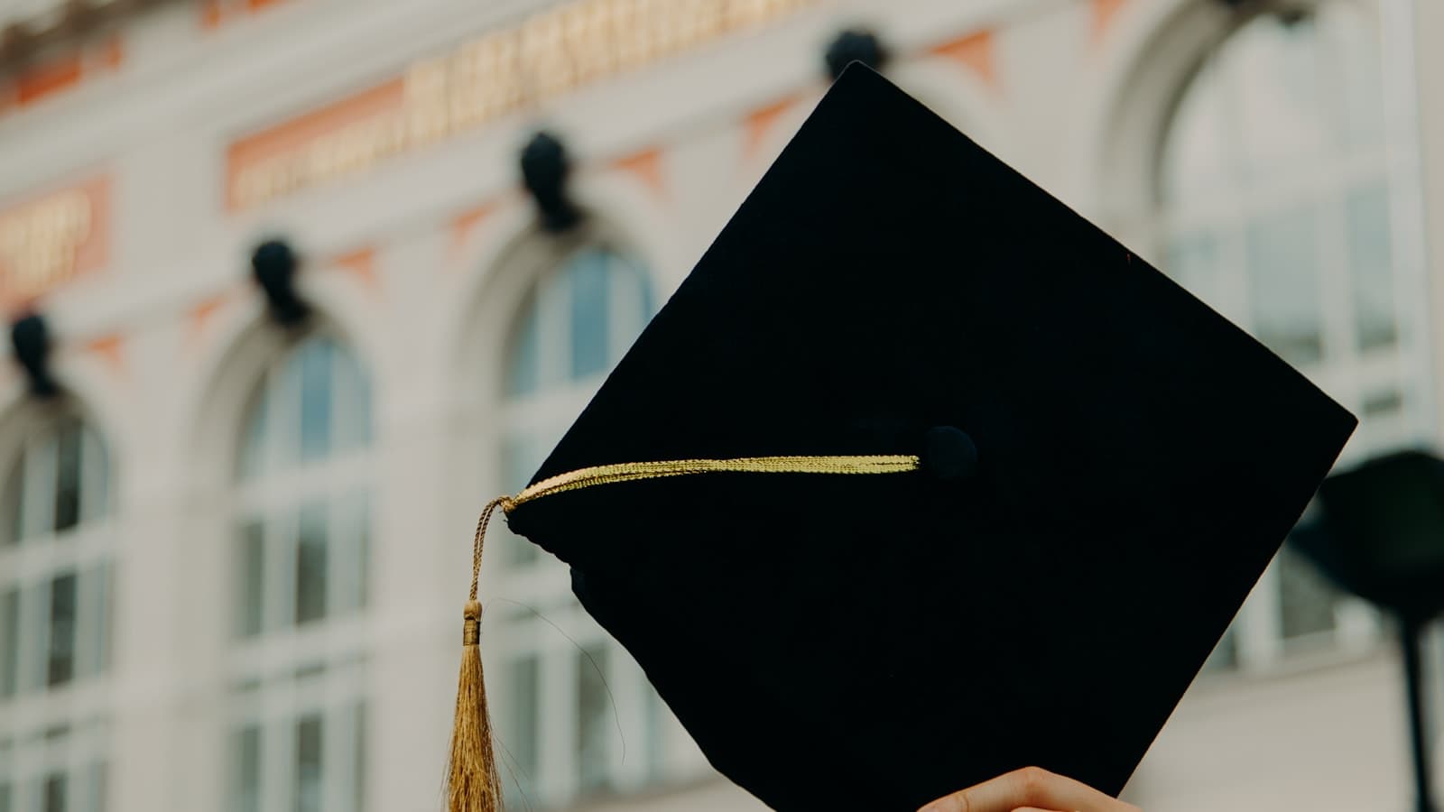University graduate holding an academic cap