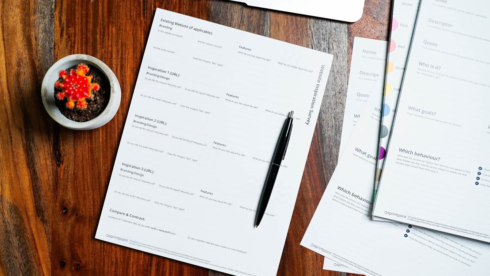 Paperwork and a pen on a wooden desk