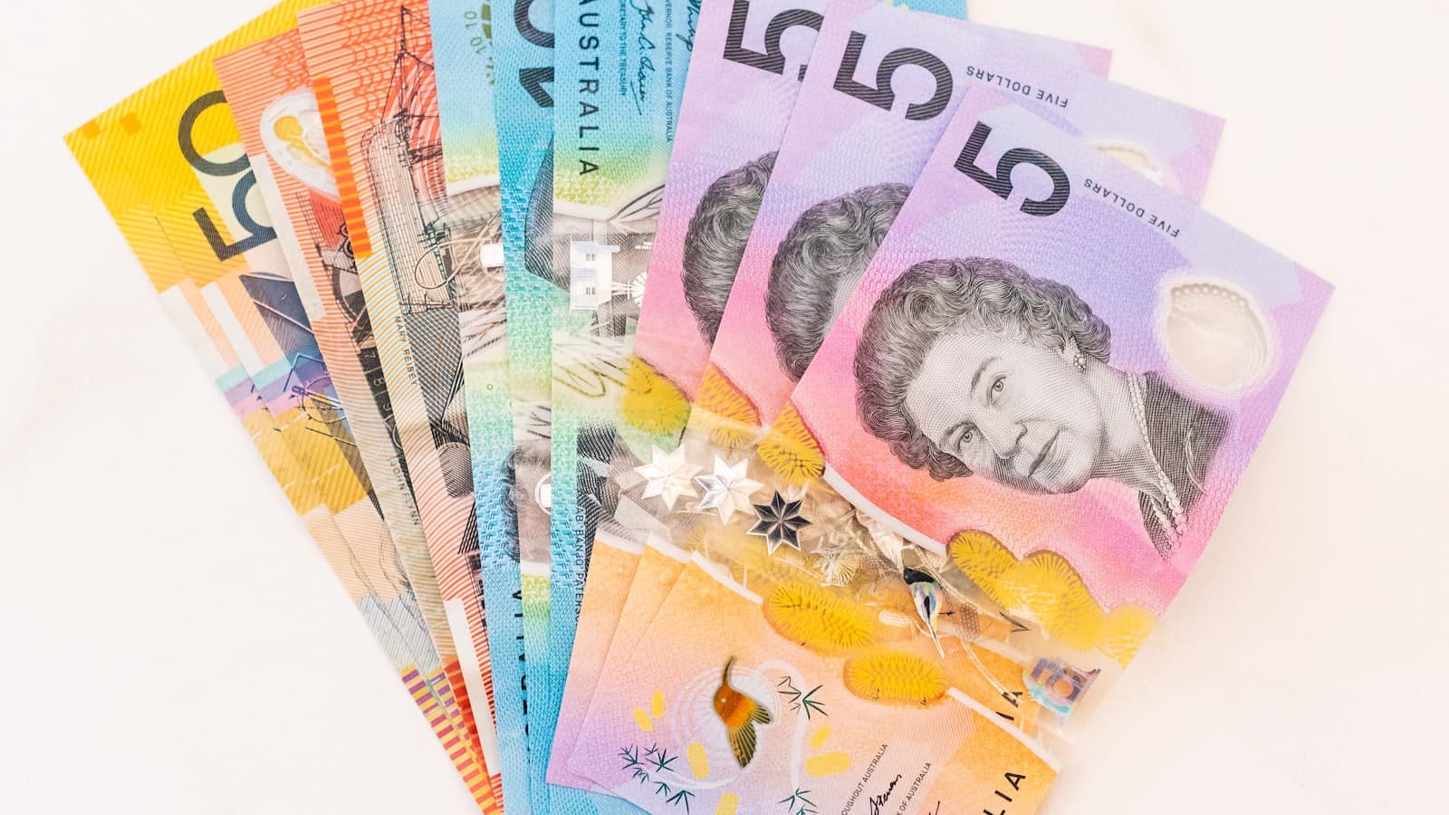 Assorted Australian dollar banknotes laid out on a table