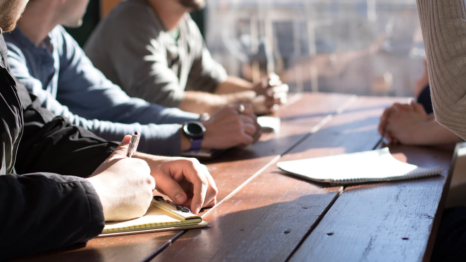Colleagues in discussion around a meeting table