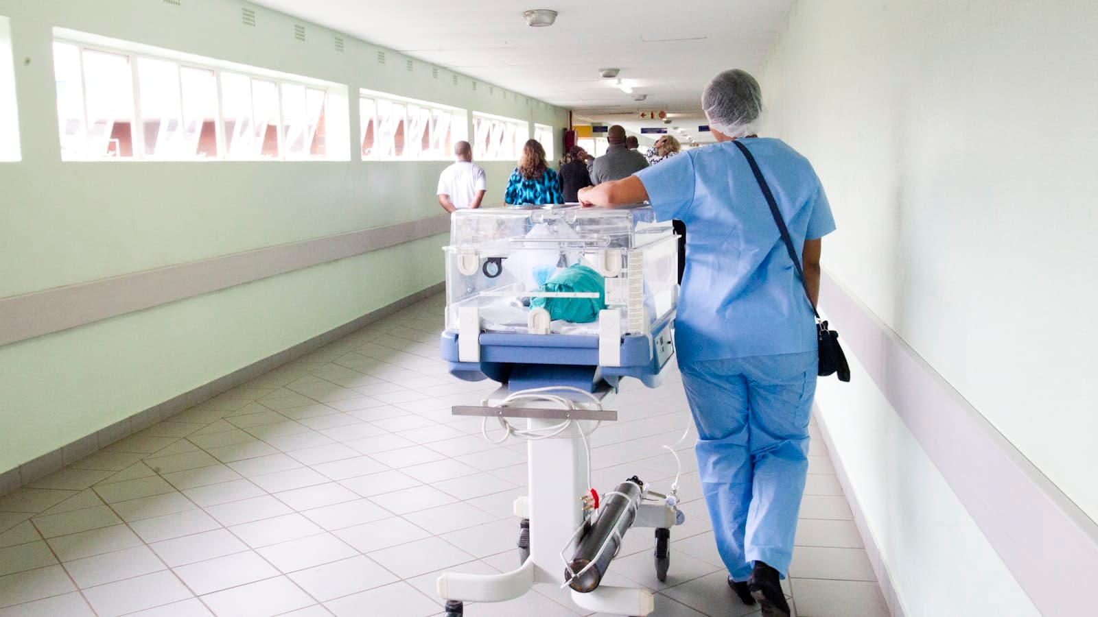Hospital corridor with staff in scrubs
