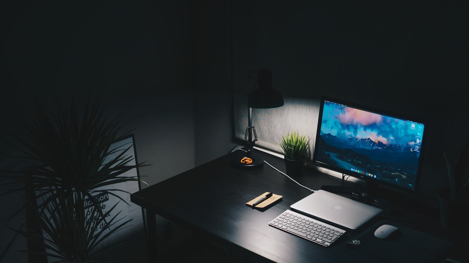 Desk with a computer set up for late-night work