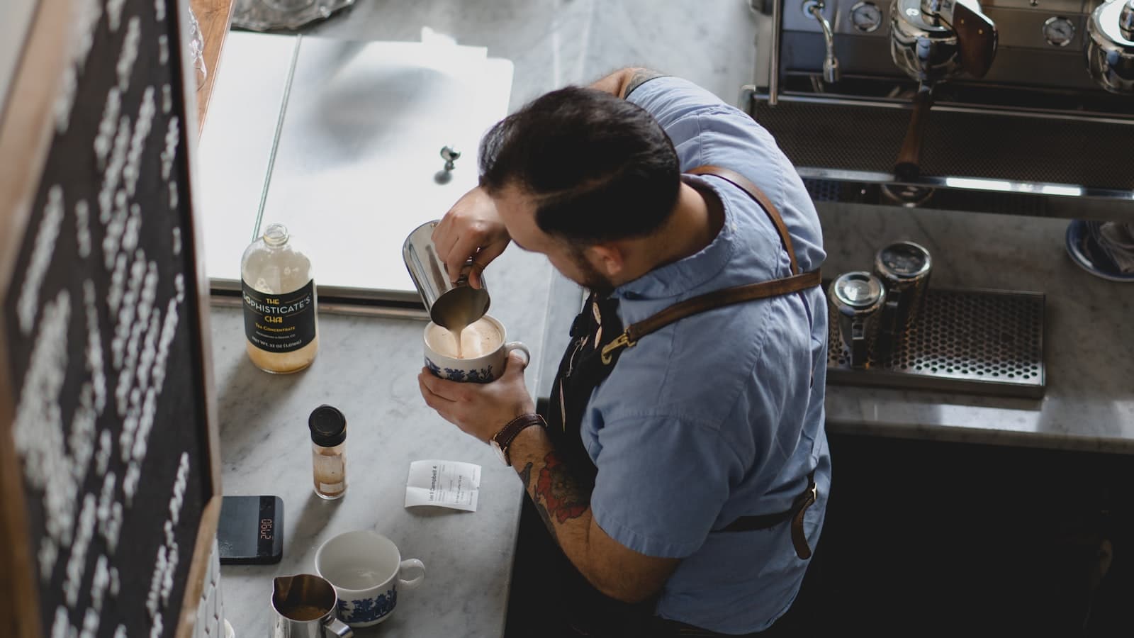Barista pouring coffee at a cafe